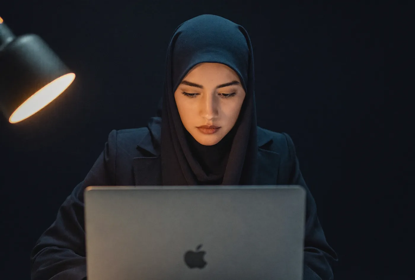An analyst working with donor data at night.